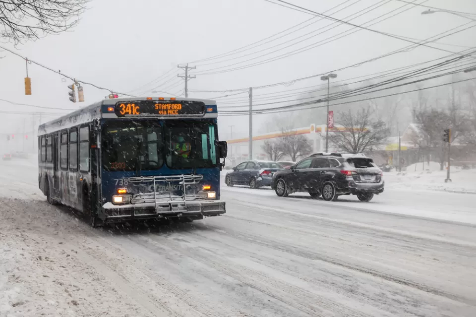 CTtransit bus driving through snowy street in Norwalk, Connecticut